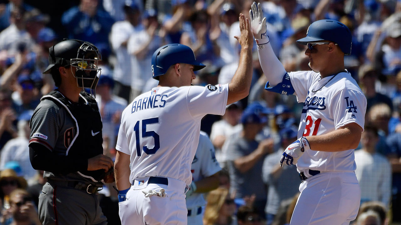 Los Angeles Dodgers' Joc Pederson, right, is congratulated by Austin Barnes, center, after hitting a two-run home run as Arizona Diamondbacks catcher John Ryan Murphy watches during the second inning of a baseball game Thursday, March 28, 2019, in Los Angeles. (Mark J. Terrill/AP)