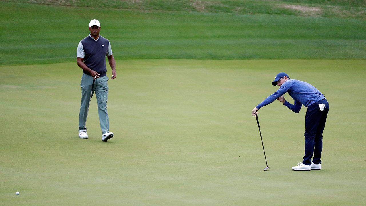 rory-mcilroy-reacts-to-missing-putt-as-tiger-woods-looks-on