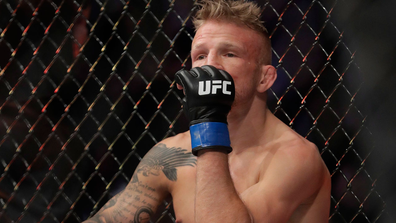 tj-dillashaw-sits-in-cage-after-losing-to-henry-cejudo