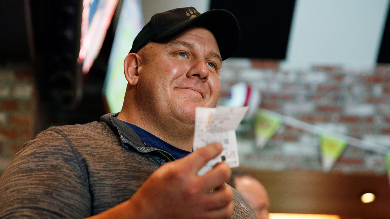 Golf-fan-holds-up-ticket-after-Tiger-wins-Masters