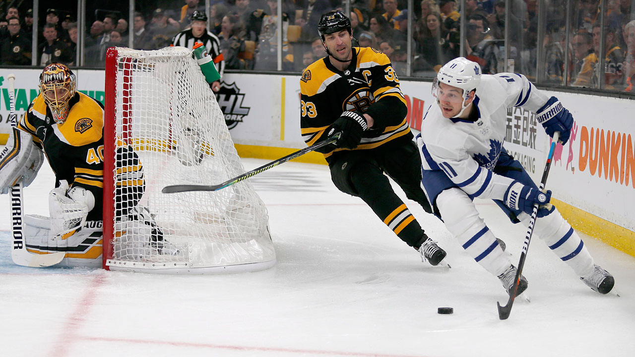 NHL-Maple-Leafs-Hyman-skates-behind-Bruins-net