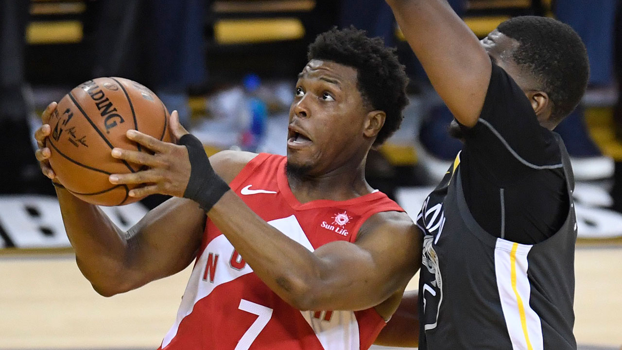 NBA-Raptors-Lowry-drives-against-Warriors-Looney