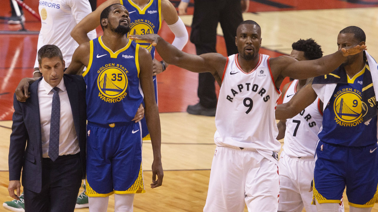 Golden-State-Warriors-forward-Kevin-Durant-(35)-walks-off-the-court-after-sustaining-an-injury-as-Toronto-Raptors-centre-Serge-Ibaka-(9)-gestures-to-the-crowd-during-first-half-basketball-action-in-Game-5-of-the-NBA-Finals-in-Toronto-on-Monday,-June-10,-2019.-(Chris-Young/CP)