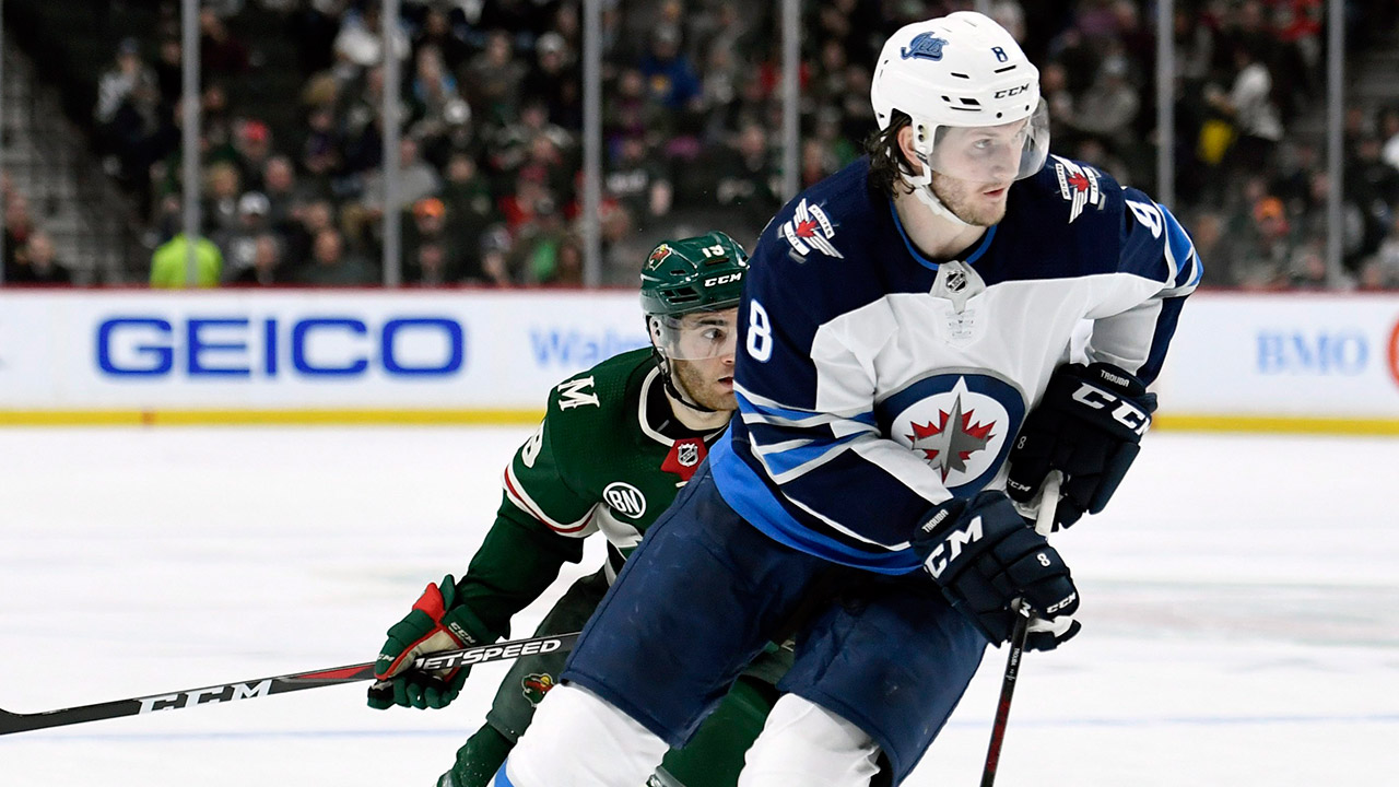 jets-defenceman-jacob-trouba-skates-with-puck-against-wild