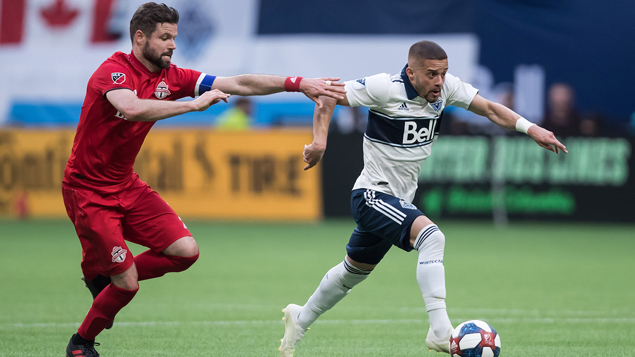 whitecaps-lucas-venuto-runs-with-ball-from-tfcs-drew-moor