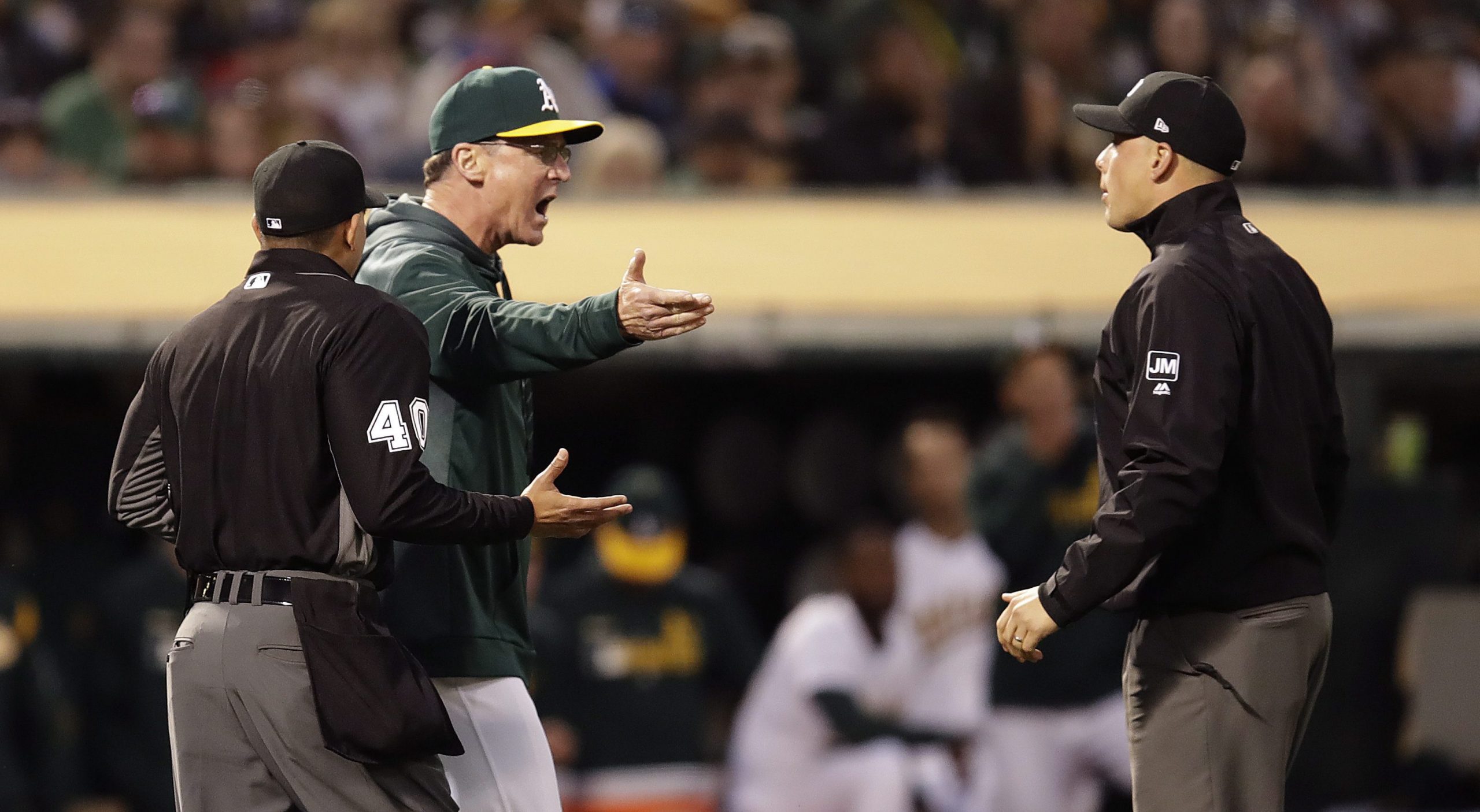 Oakland-Athletics-manager-Bob-Melvin,-second-from-left,-speaks-with-third-base-umpire-Stu-Scheurwater,-right,-and-home-plate-umpire-Roberto-Ortiz,-left,-duripng-the-fifth-inning-of-the-team's-baseball-game-against-the-Houston-Astros-on-Saturday,-June-1,-2019,-in-Oakland,-Calif.-(AP-Photo/Ben-Margot)
