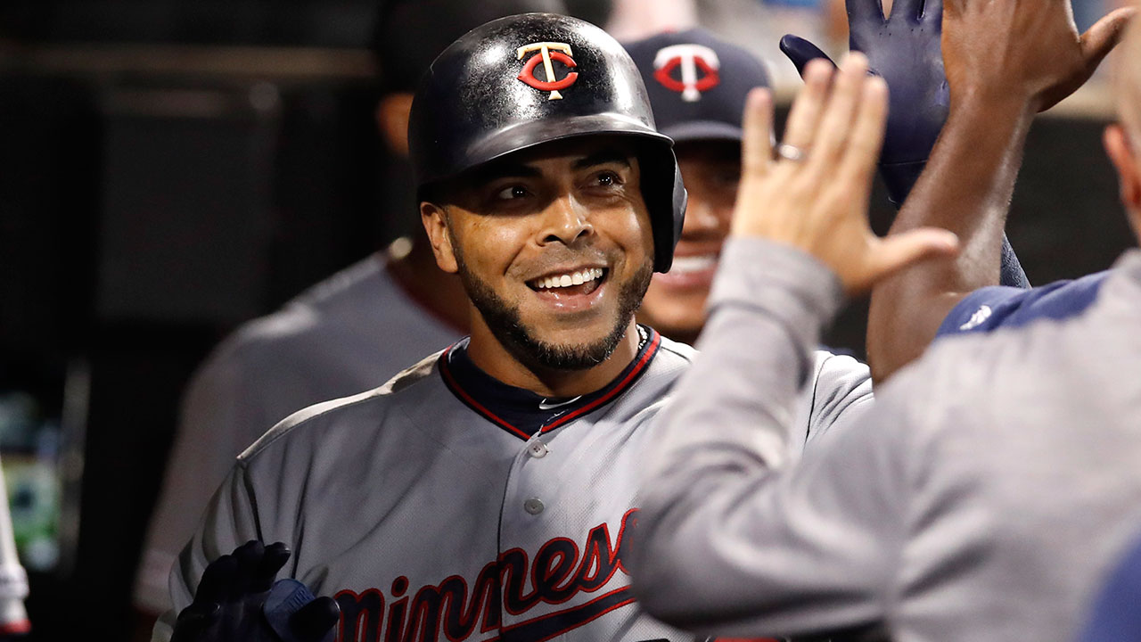 Minnesota Twins' Nelson Cruz celebrates with teammates in the dugout after hitting a solo home run. (Jeff Haynes/AP)