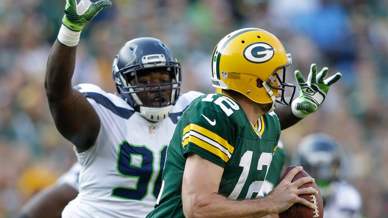 Jarran Reed attempts to rush Packers quarterback Aaron Rodgers