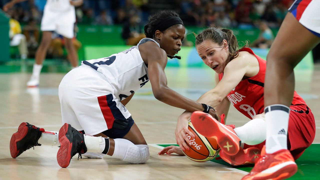 France's Olivia Epoupa, left, fights for a loose ball with Canada's Kim Gaucher, right, during a quarterfinal round basketball game. (Charlie Neibergall/AP)