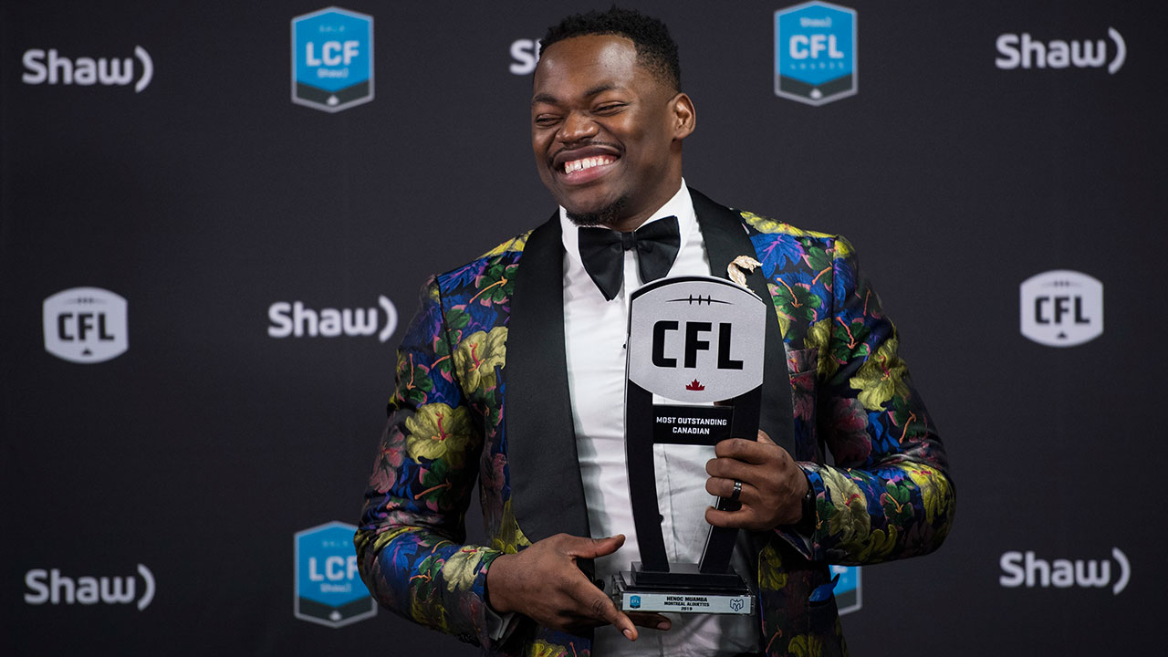 Montreal Alouettes linebacker Henoc Muamba poses with the trophy for the most outstanding Canadian award at the CFL Awards during the CFL's Grey Cup week. (Nathan Denette/CP)