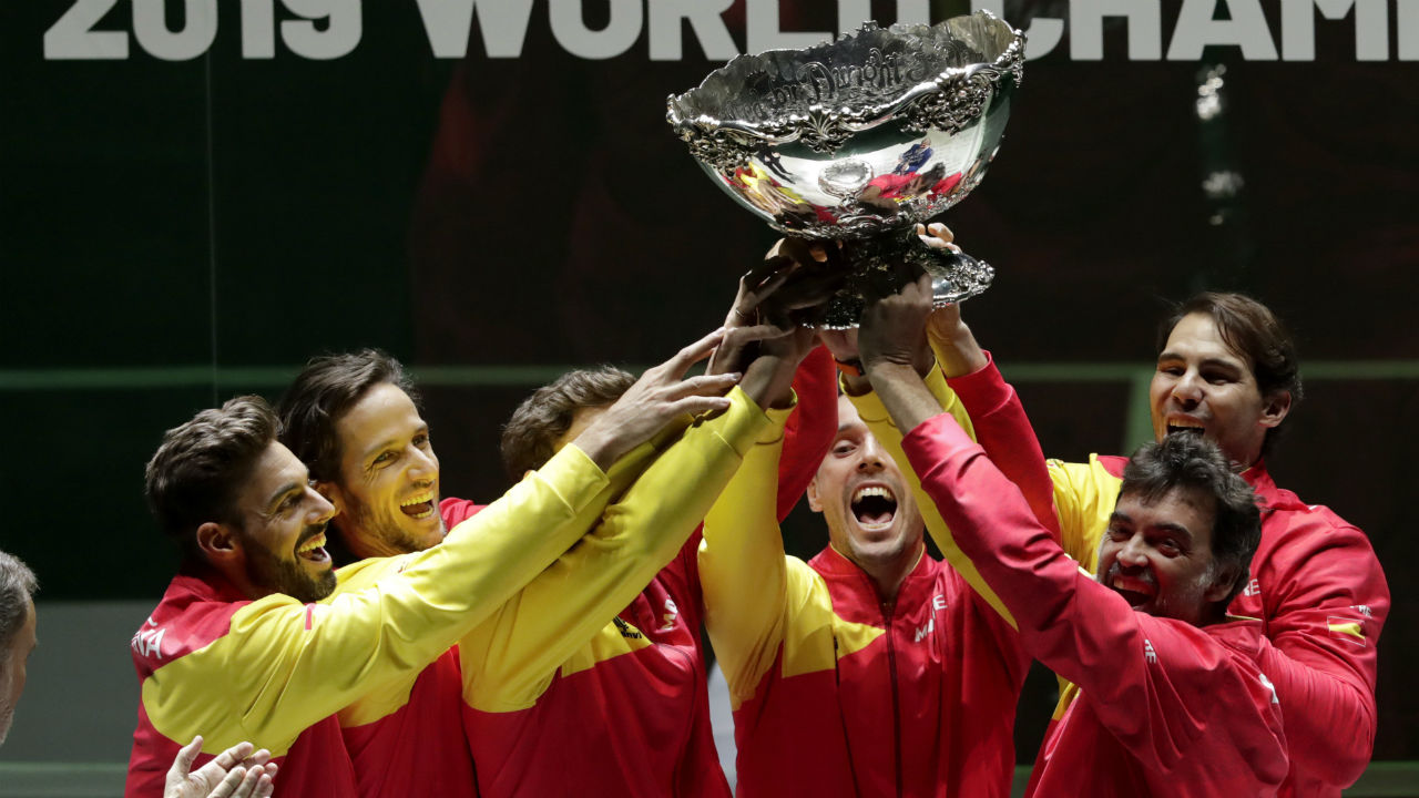 The Spanish team poses with the trophy after Spain defeated Canada 2-0 to win the Davis Cup final. (Bernat Armangue/AP)