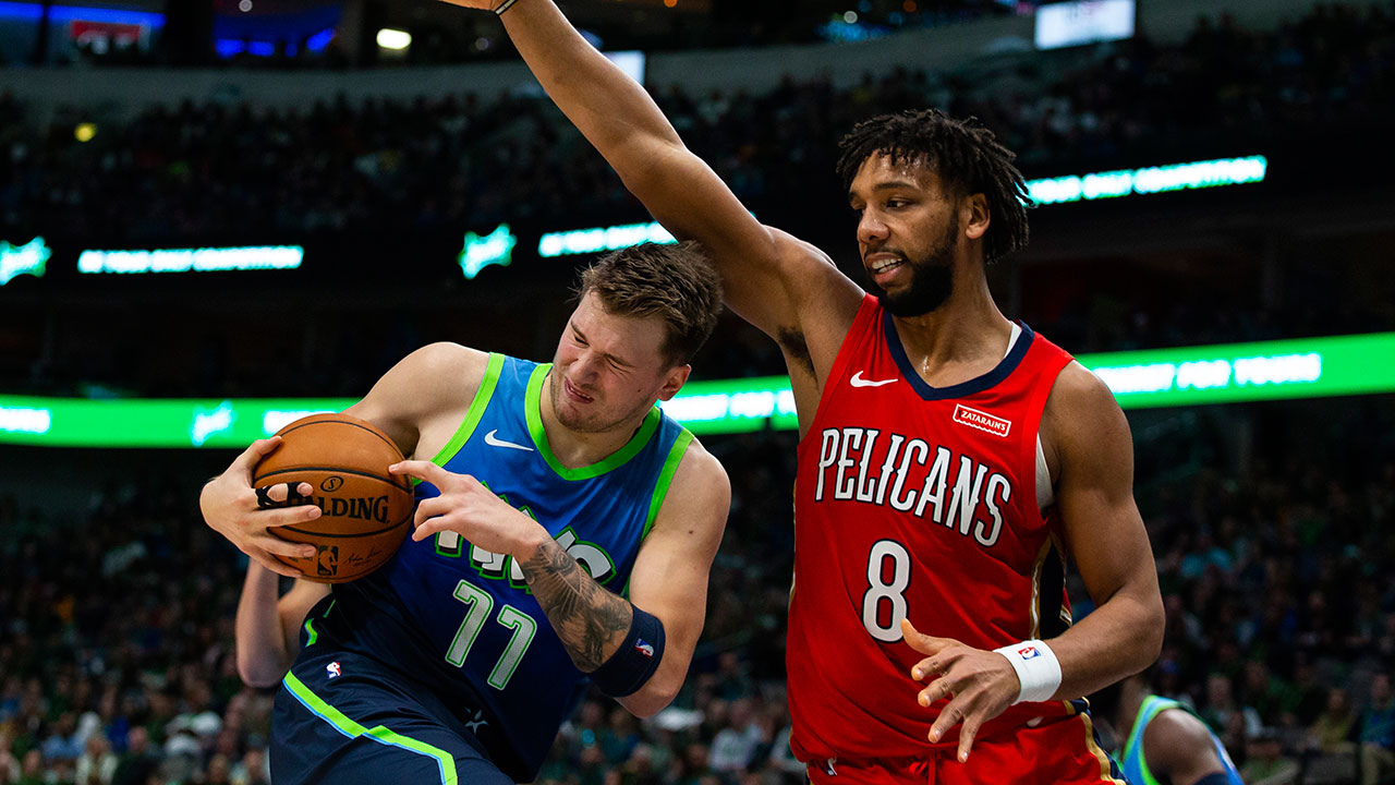 Dallas Mavericks forward Luka Doncic (77) rebounds the ball as New Orleans Pelicans center Jahlil Okafor (8) defends during the third quarter of an NBA basketball game Saturday, Dec. 7, 2019 in Dallas. (Sam Hodde/AP)