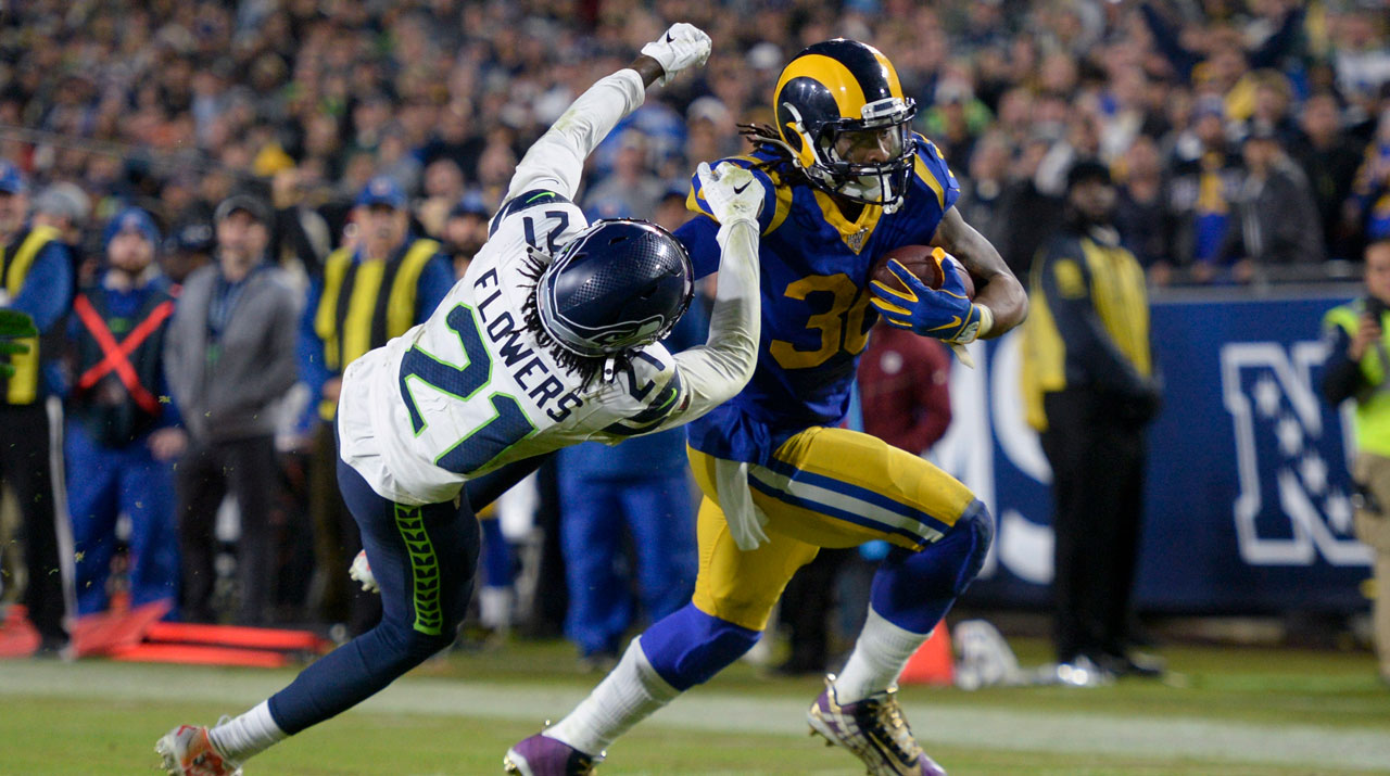 Los Angeles Rams running back Todd Gurley, right, scores past Seattle Seahawks cornerback Tre Flowers during the second half of an NFL football game. (Kyusung Gong/AP)