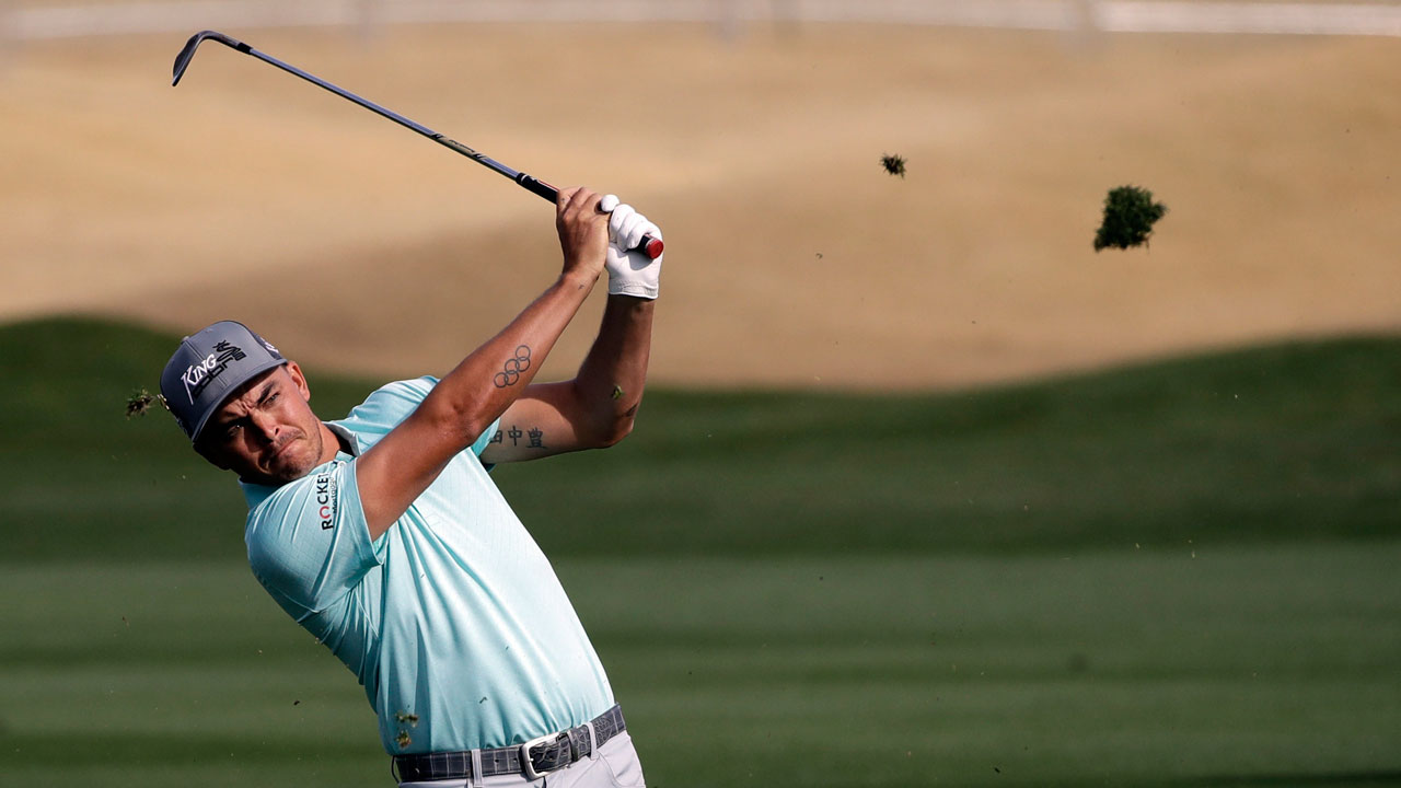 Rickie Fowler follows through on his shot from the ninth fairway during the second round of The American Express golf tournament on the Nicklaus Tournament Course at PGA West. (Marcio Jose Sanchez/AP)