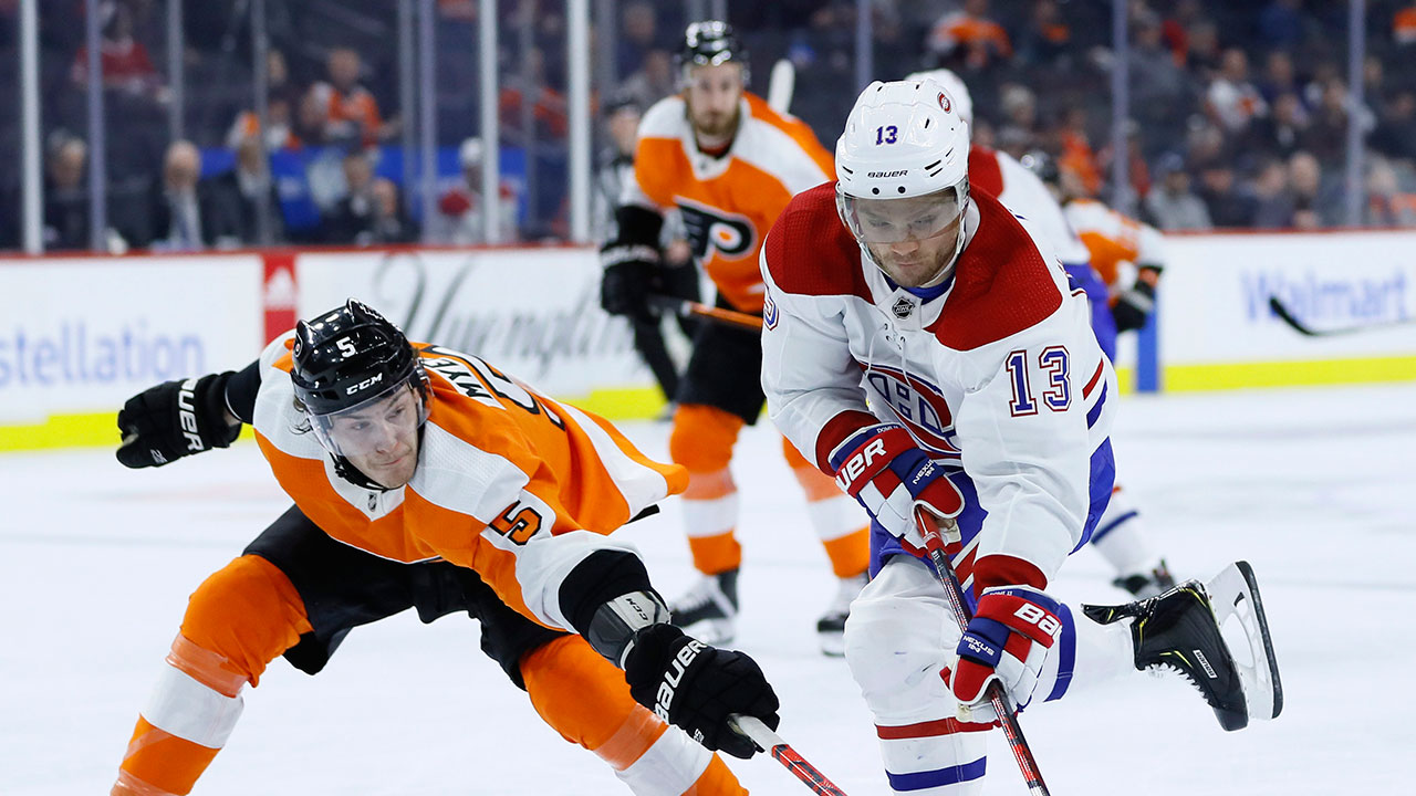 Philadelphia Flyers' Philippe Myers, left, tips the puck away from Montreal Canadiens' Max Domi during the third period of an NHL hockey game, Thursday, Jan. 16, 2020, in Philadelphia. (Matt Slocum/AP)