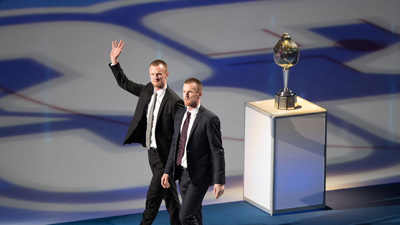 Former Vancouver Canucks players Henrik Sedin, left, and Daniel Sedin during a jersey retirement ceremony. (Darryl Dyck / CP)