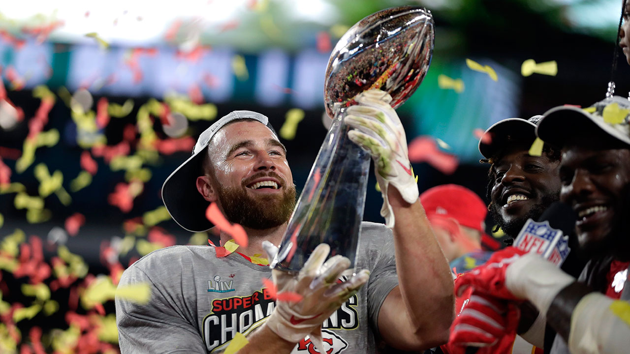 The Kansas City Chiefs' Travis Kelce hoists the trophy after defeating the San Francisco 49ers in Super Bowl 54. (David J. Phillip/AP)