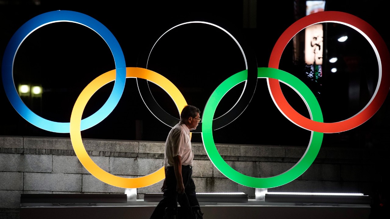 A man walks past the Olympic rings in Tokyo. (Jae C. Hong/CP/AP)