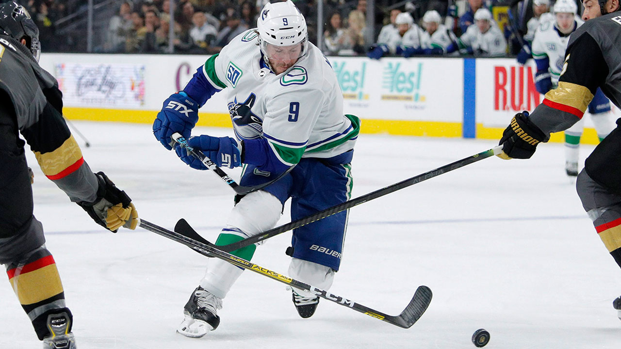Vancouver Canucks' J.T. Miller (9) skates between Vegas Golden Knights defensemen Brayden McNabb, left, and Deryk Engelland. (John Locher/AP)