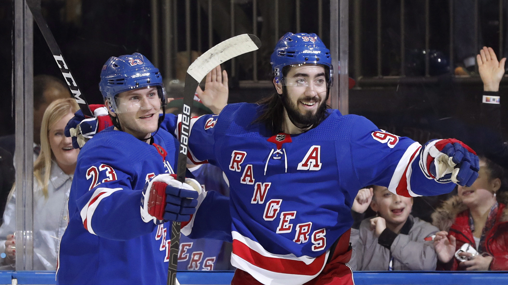 New York Rangers defenseman Adam Fox (23) and center Mika Zibanejad (93) celebrate as they wait for a teammate to join them after Zibanejad scored a goal during the second period of the team's NHL hockey game against the Washington Capitals. (Kathy Willens/AP)