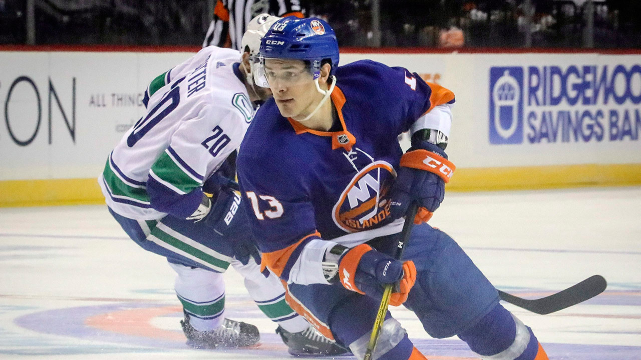 New-York-Islanders-forward-Mathew-Barzal-controls-the-puck-during-an-NHL-hockey-game-against-Vancouver-Canucks