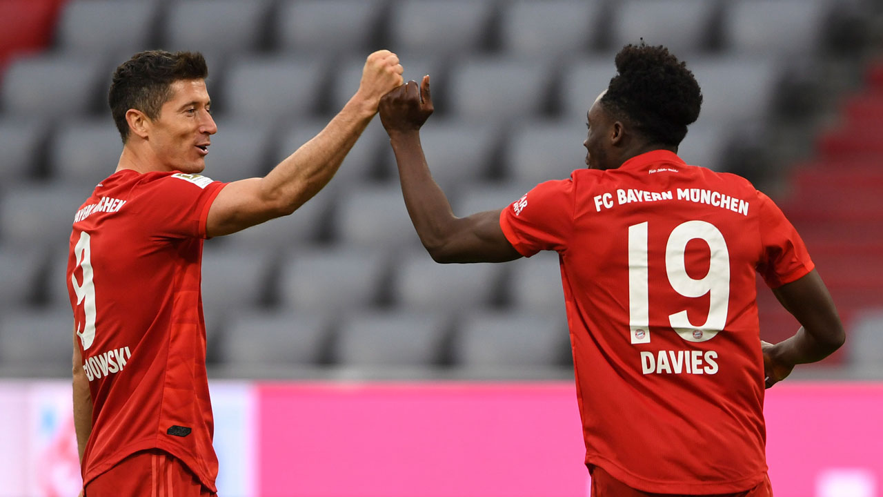 Munich's Robert Lewandowski, left, and team mate Alphonso Davies celebrate. (Christof Stache/AP)