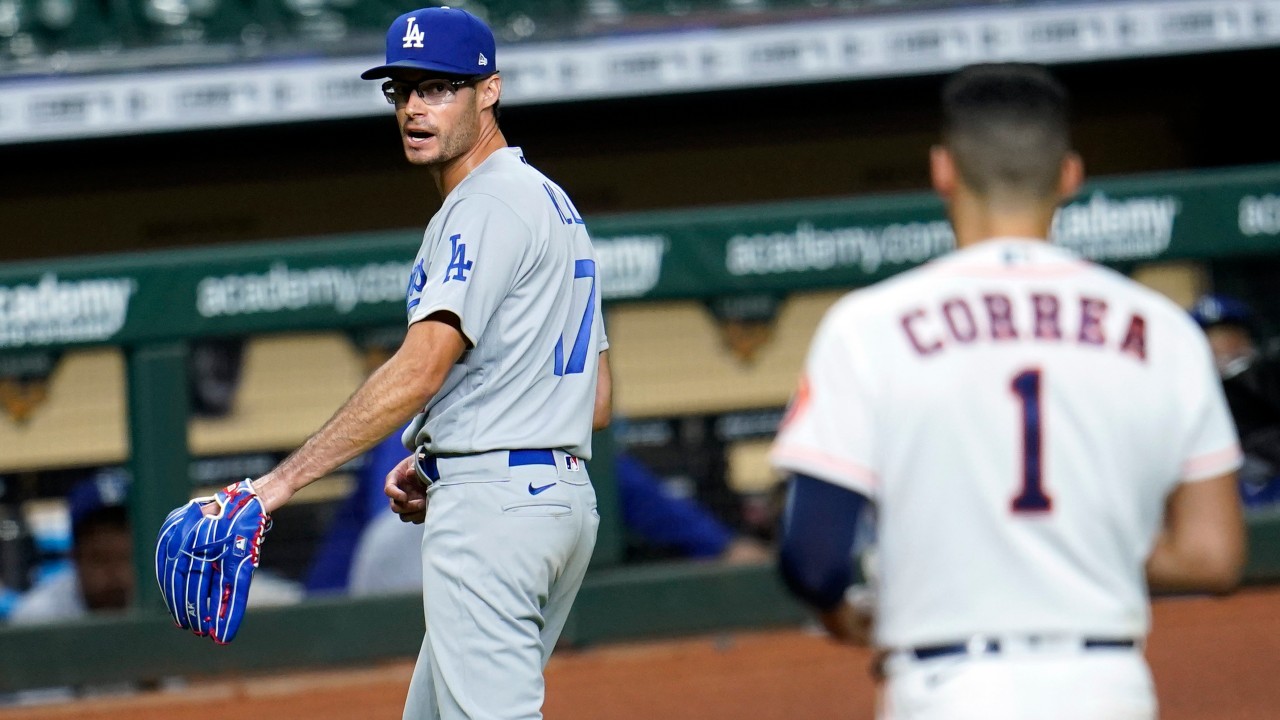 Los Angeles Dodgers relief pitcher Joe Kelly (17) looks back at Houston Astros' Carlos Correa (1) after the sixth inning of a baseball game Tuesday, July 28, 2020, in Houston. Both benches emptied during the exchange. (David J. Phillip / AP)