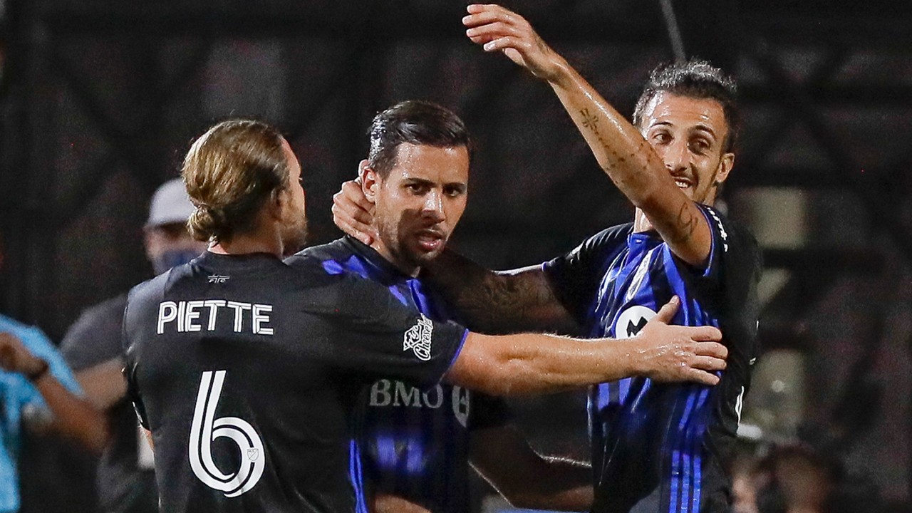 Montreal Impact midfielder Samuel Piette (6) and forward Maximiliano Urruti, right, celebrate with midfielder Saphir Taider, center, after Taider scored a goal against D.C. United during the first half of an MLS soccer match, Tuesday, July 21, 2020, in Kissimmee, Fla. (John Raoux / AP)