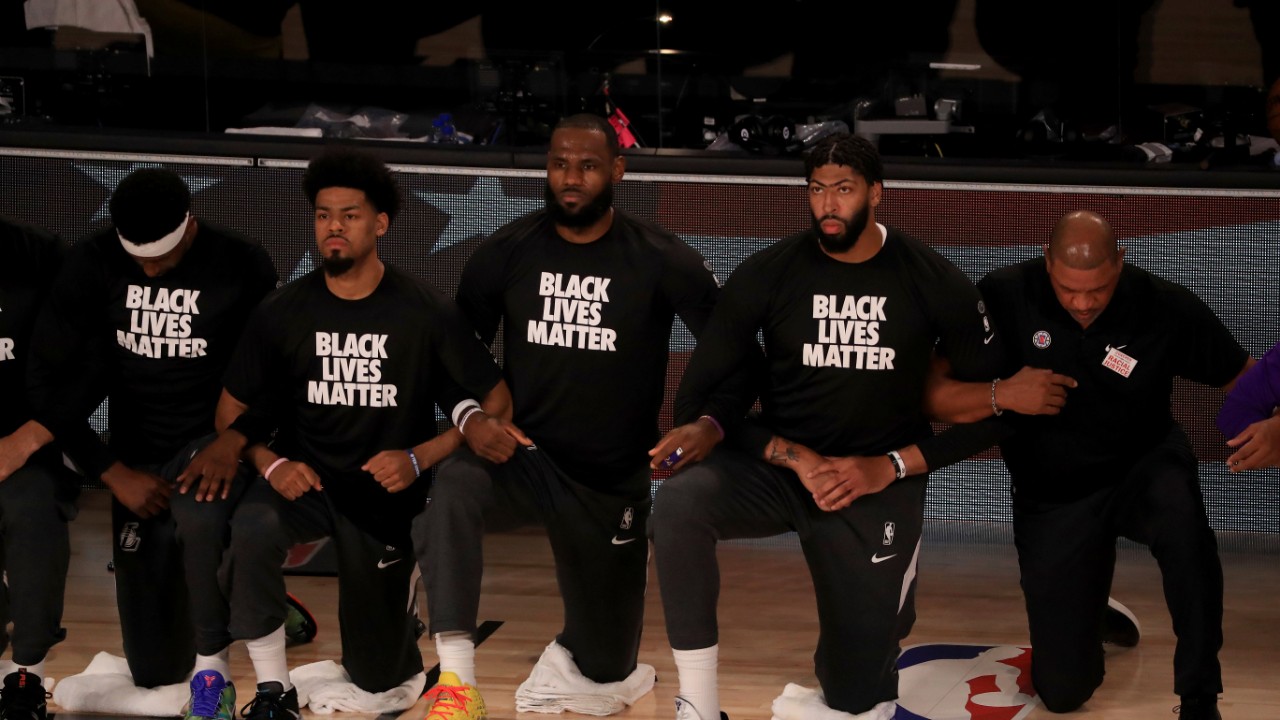 NBA players and coaches kneel and link arms during national anthem