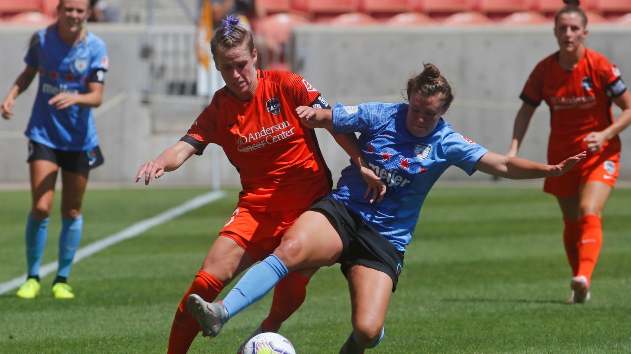 Houston Dash's Sophie Schmidt, left, and Chicago Red Stars' Savannah McCaskill, right, battle for the ball during the second half of an NWSL Challenge Cup soccer finals match Sunday, July 26, 2020, in Sandy, Utah. (Rick Bowmer/AP)