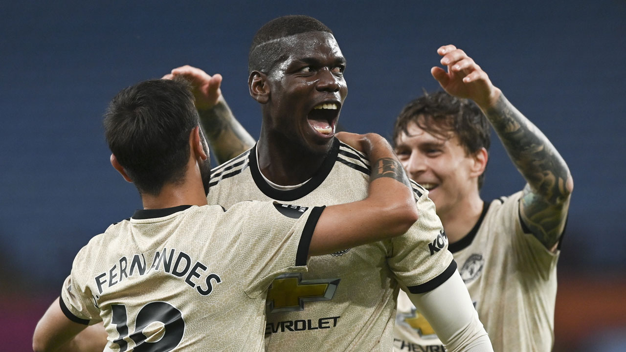 Manchester United's Paul Pogba, centre, celebrates with teammates after scoring his team's third goal during the English Premier League soccer match between Aston Villa and Manchester United. (Shaun Botterill/AP)