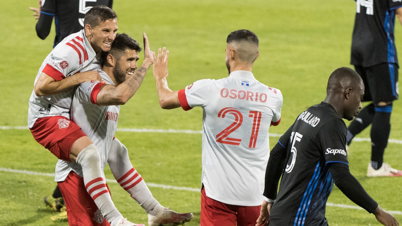 Toronto FC midfielder Alejandro Pozuelo, centre, celebrates with teammates Pablo Piatti, left, and Jonathan Osorio after scoring from the penalty spot during second half MLS soccer action against the Montreal Impact. (Graham Hughes/CP)