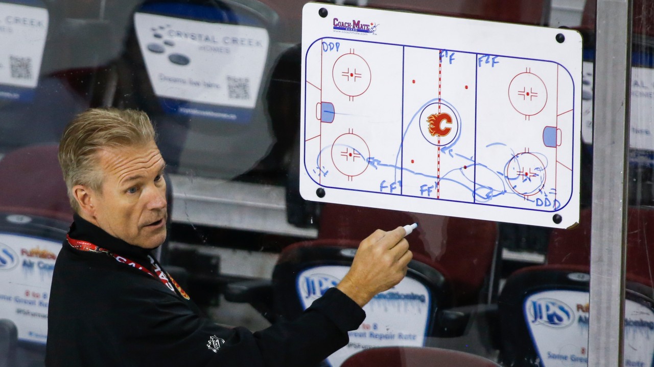 Calgary Flames' head coach Geoff Ward draws out a drill during team practice in Calgary. (Jeff McIntosh / CP)