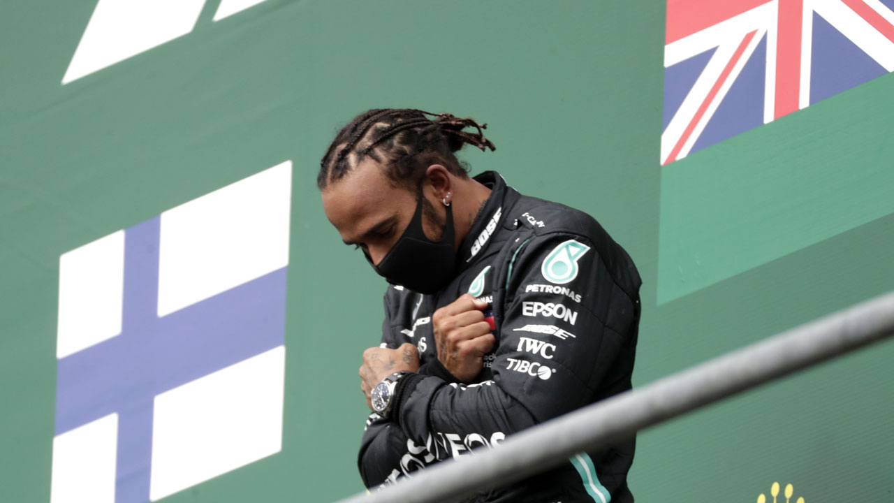 Mercedes driver Lewis Hamilton of Britain celebrates on the podium after winning the Formula One Grand Prix at the Spa-Francorchamps racetrack in Spa. (Stephanie Lecocq/AP)
