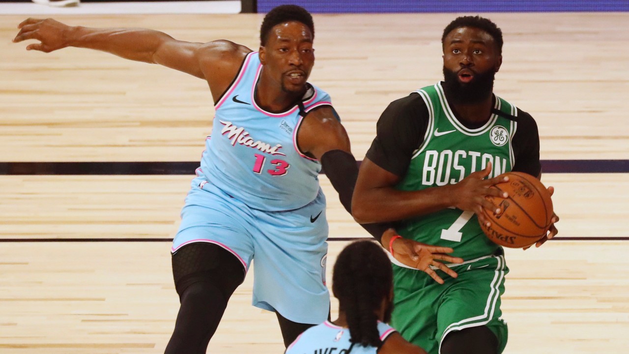 Boston Celtics guard Jaylen Brown (7) drives against Miami Heat forward Bam Adebayo (13) during the first half of an NBA basketball game. (Kim Klement/Pool Photo via AP)