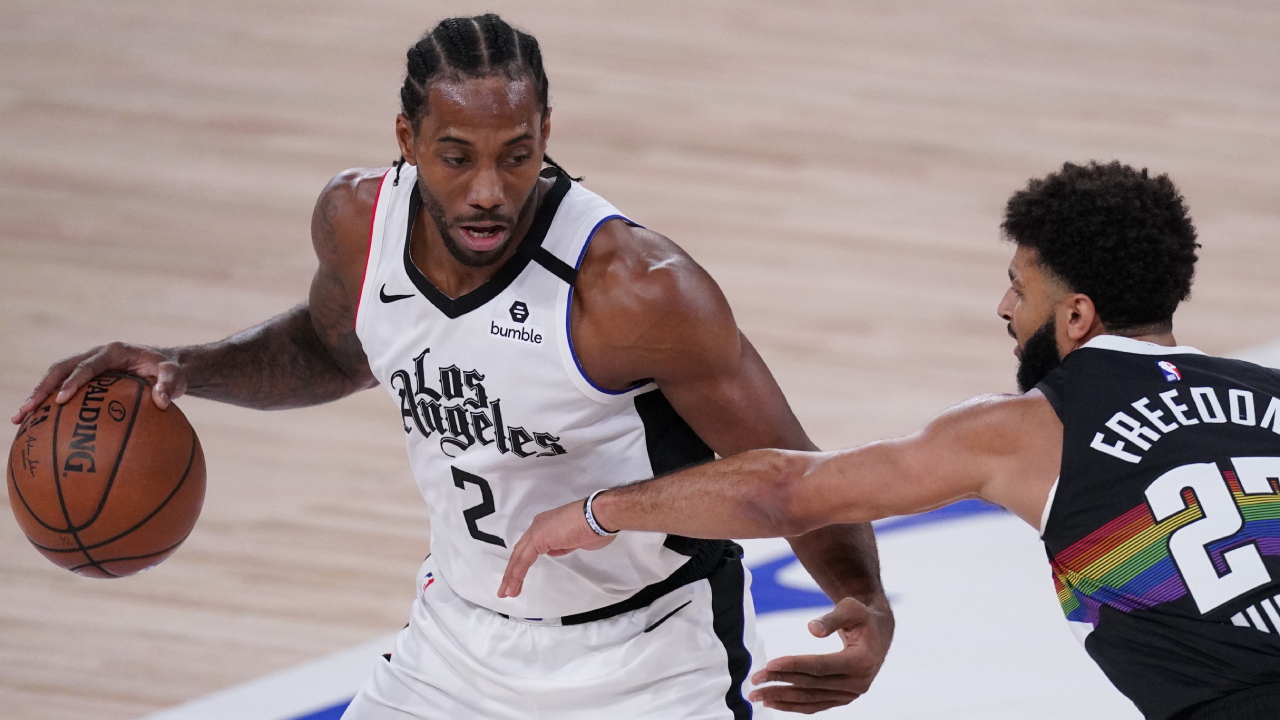 Los Angeles Clippers' Kawhi Leonard (2) tries to get past Denver Nuggets' Jamal Murray (27) during the first half of an NBA conference semifinal playoff basketball game Monday, Sept. 7, 2020, in Lake Buena Vista, Fla. (Mark J. Terrill/AP)