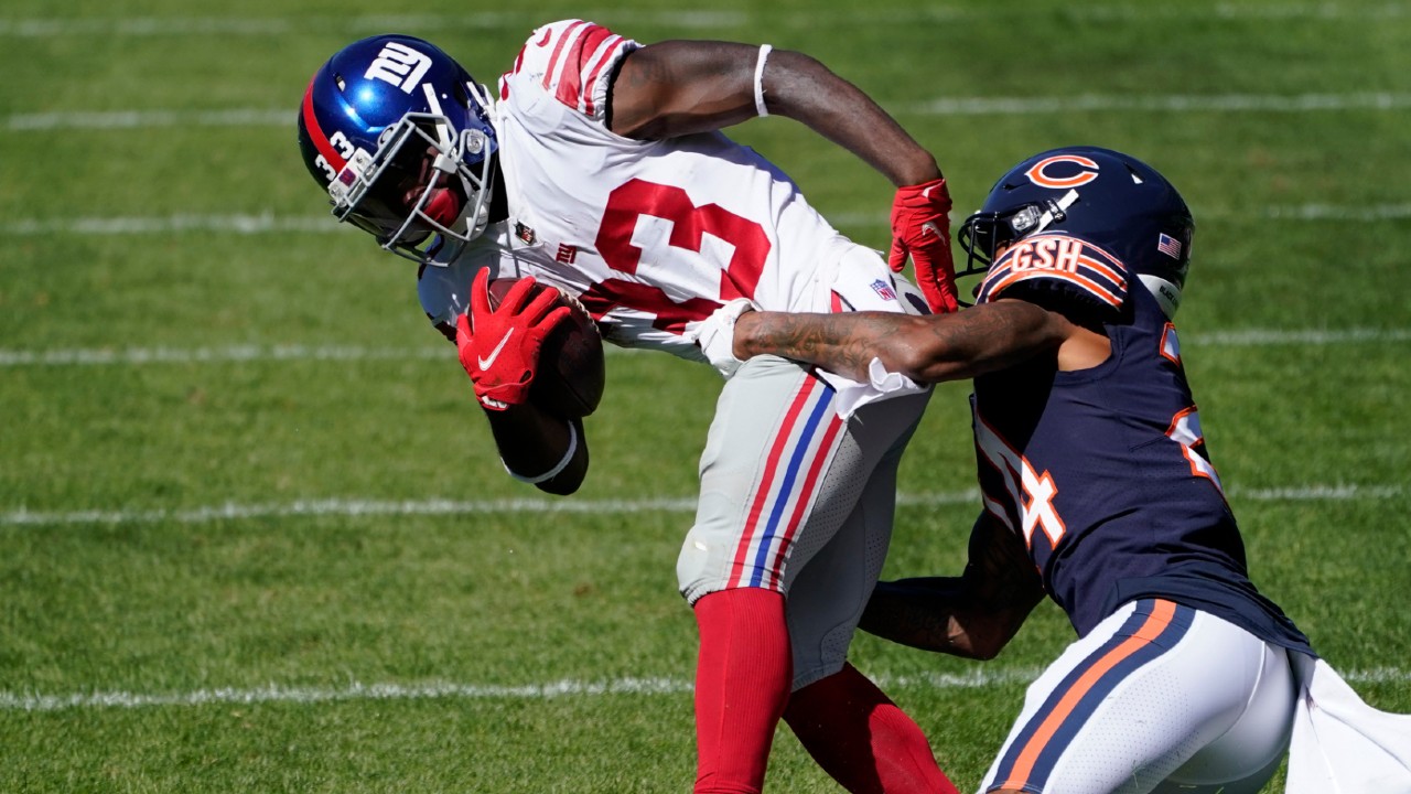 New York Giants running back Dion Lewis tries to break free from Chicago Bears cornerback Buster Skrine. (Charles Rex Arbogast/AP)