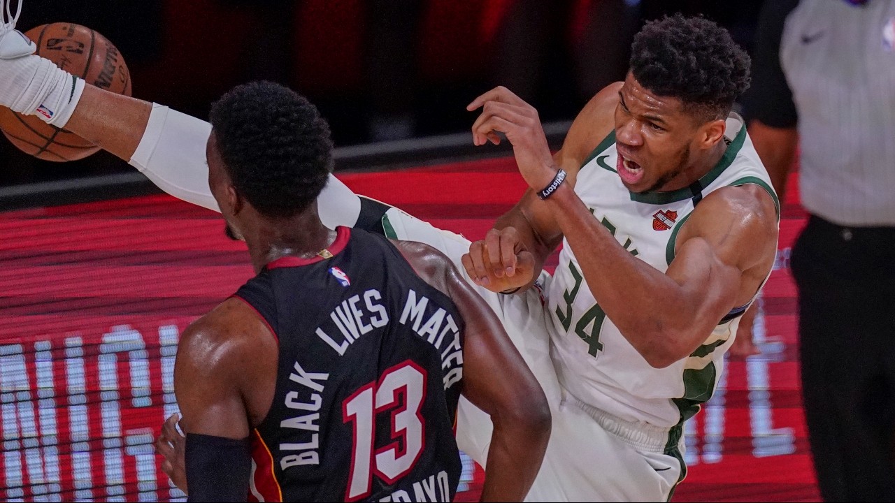 Milwaukee Bucks' Giannis Antetokounmpo dunks over Miami Heat's Bam Adebayo during the first half of an NBA conference semifinal playoff basketball game. (Mark J. Terrill/AP) 