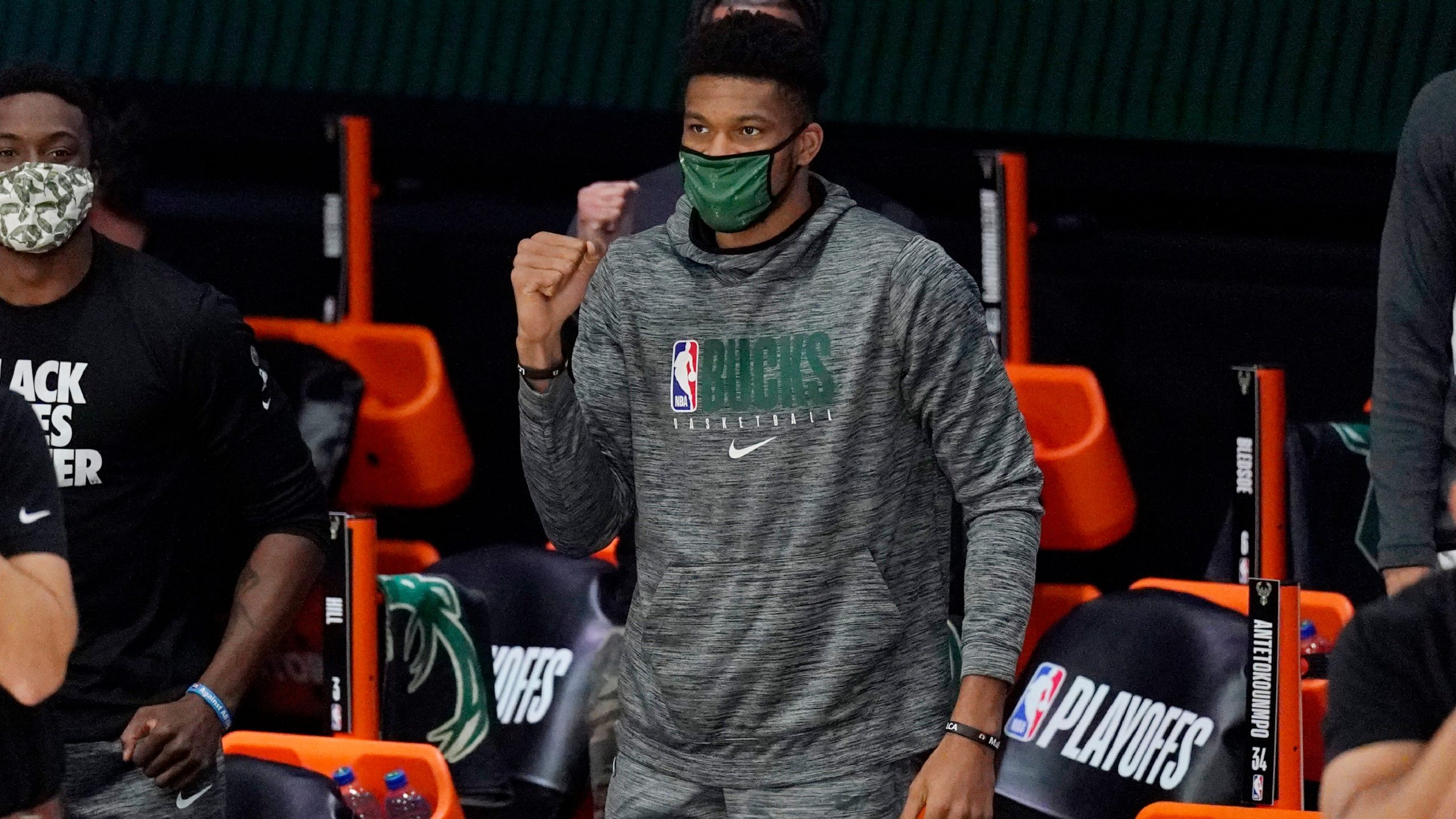 Milwaukee Bucks' Giannis Antetokounmpo, center, watches from the bench in the first half of an NBA conference semifinal playoff basketball game against the Miami Heat. (Mark J. Terrill/AP) 
