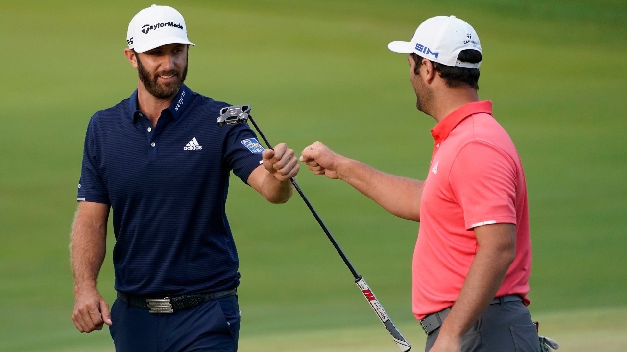 Jon Rahm, right, is congratulated by Dustin Johnson on the first playoff hole during the final round of the BMW Championship golf tournament. (Charles Rex Arbogast/AP)