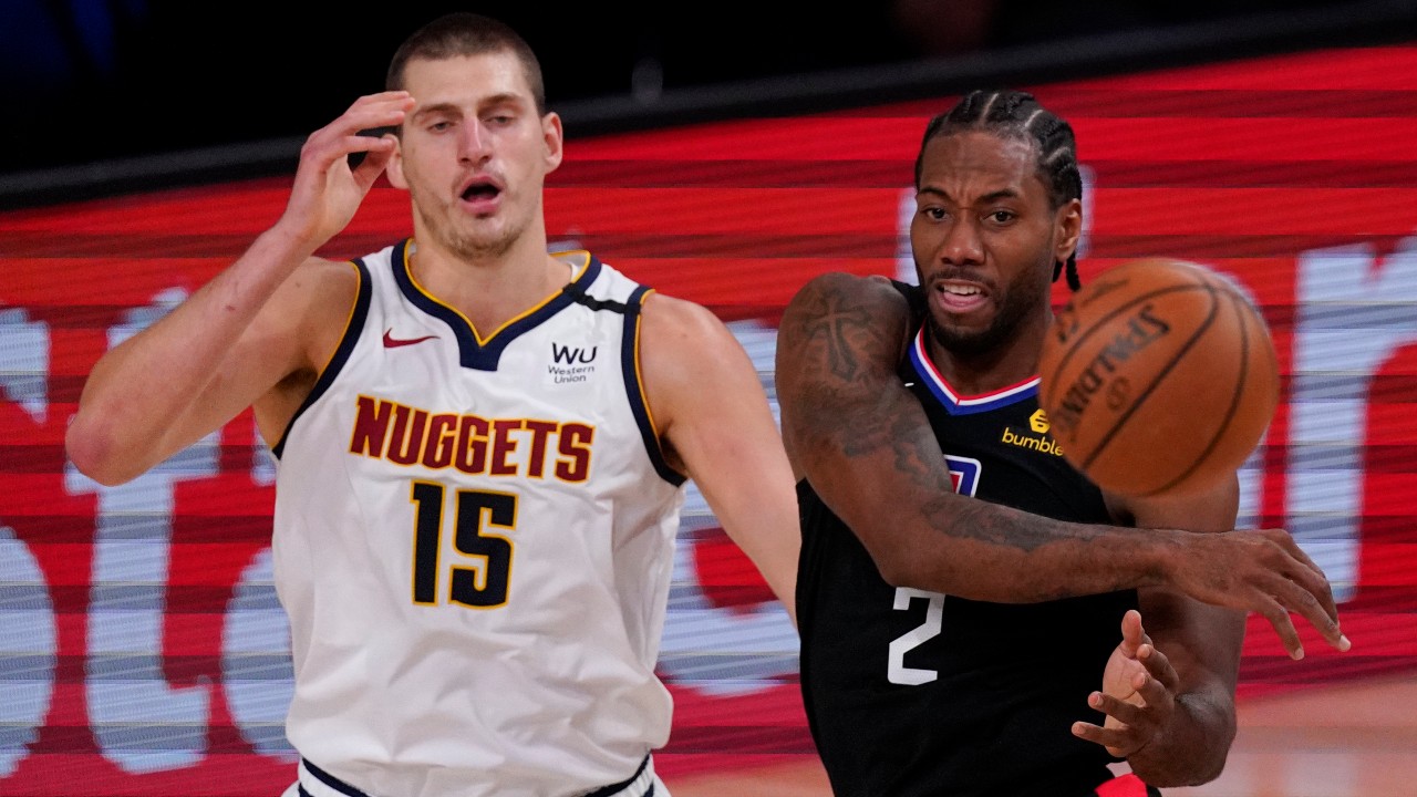 Los Angeles Clippers' Kawhi Leonard (2) passes in front of Denver Nuggets' Nikola Jokic (15) during the first half of an NBA conference semifinal playoff basketball game. (Mark J. Terrill/AP)