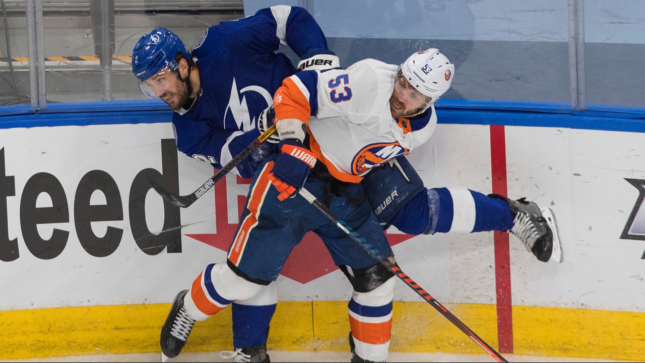 Tampa Bay Lightning's Luke Schenn (2) is checked by New York Islanders' Casey Cizikas (53). (Jason Franson/CP)