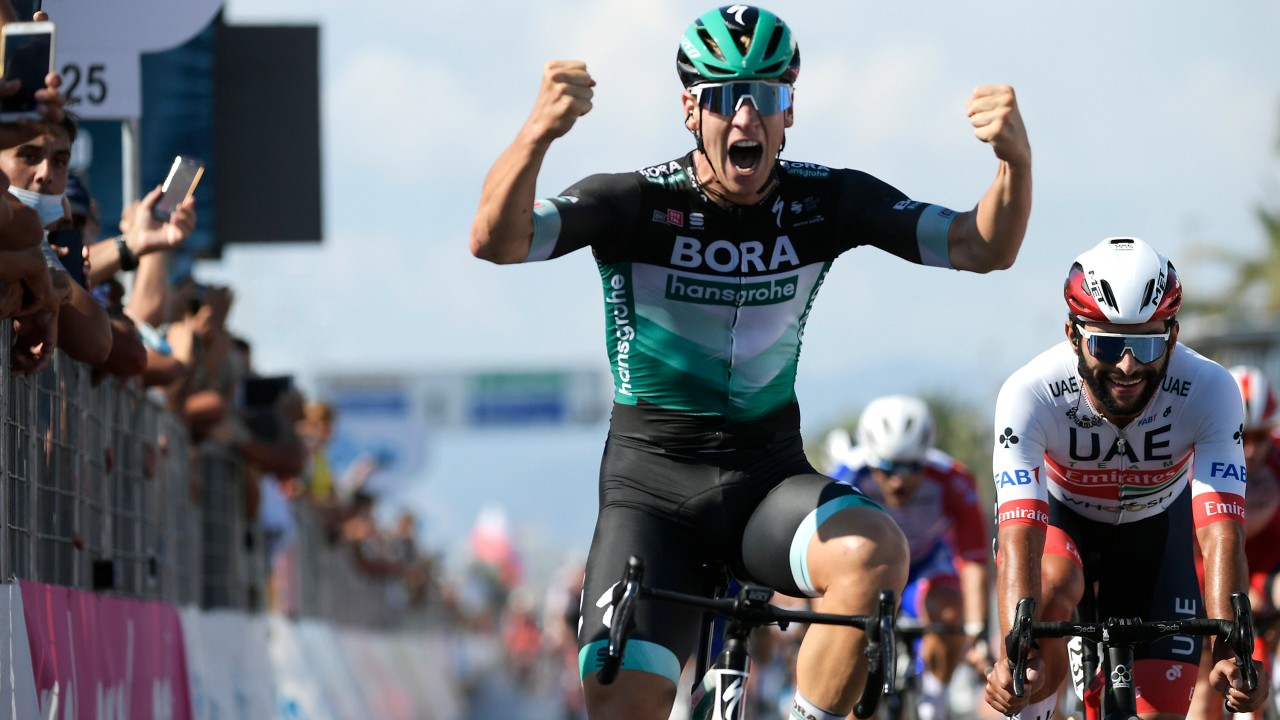 Germany's Pascal Ackermann celebrates as he crosses the finish line to win the first stage of the Tirreno Adriatico cycling race in Lido di Camaiore, Italy, Monday, Sept. 7, 2020. (Marco Alpozzi/LaPresse via AP)