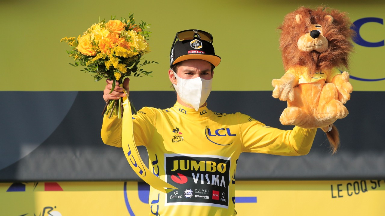 Slovenia's Primoz Roglic, wearing the overall leader's yellow jersey, celebrates on the podium after stage 15 of the Tour de France. (Christophe Petit-Tesson/Pool via AP)