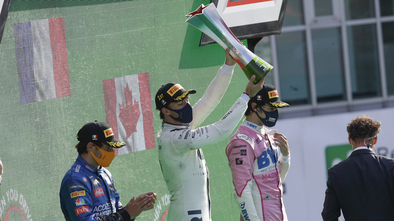 AlfaTauri driver Pierre Gasly of France, center, winner of the Italian Formula One Grand Prix, celebrates on podium with second placed Mclaren driver Carlos Sainz of Spain, left, and third placed Racing Point driver Lance Stroll of Canada, at the Monza racetrack in Monza. (Luca Bruno/AP)
