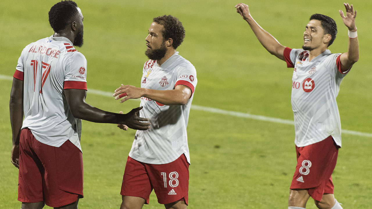 Toronto FC’s Jozy Altidore (17) celebrates with teammates Nick DeLeon (18) and Mark Delgado (8) after scoring during second half MLS soccer action. (Graham Hughes/CP)