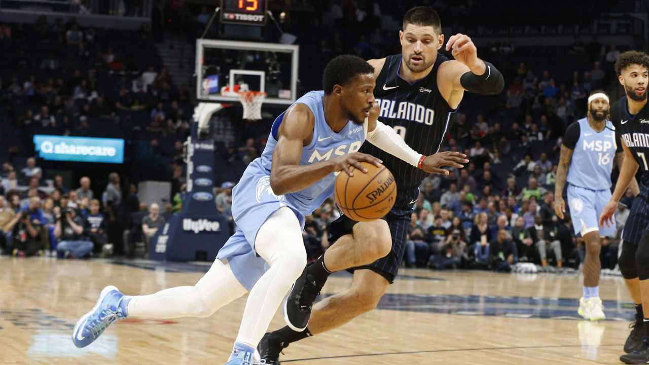 Minnesota Timberwolves' Malik Beasley, left, drives past Orlando Magic's Nikola Vucevic in the second half of an NBA basketball game. (Jim Mone/AP)