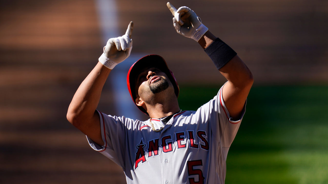 Los Angeles Angels' Albert Pujols gestures as he crosses home plate after hitting a two-run home run. (David Zalubowski/AP)