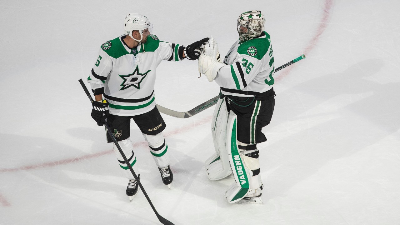 Dallas Stars defenceman Andrej Sekera (5) and goalie Anton Khudobin (35) celebrate a win over the Calgary Flames. (Jason Franson/CP)