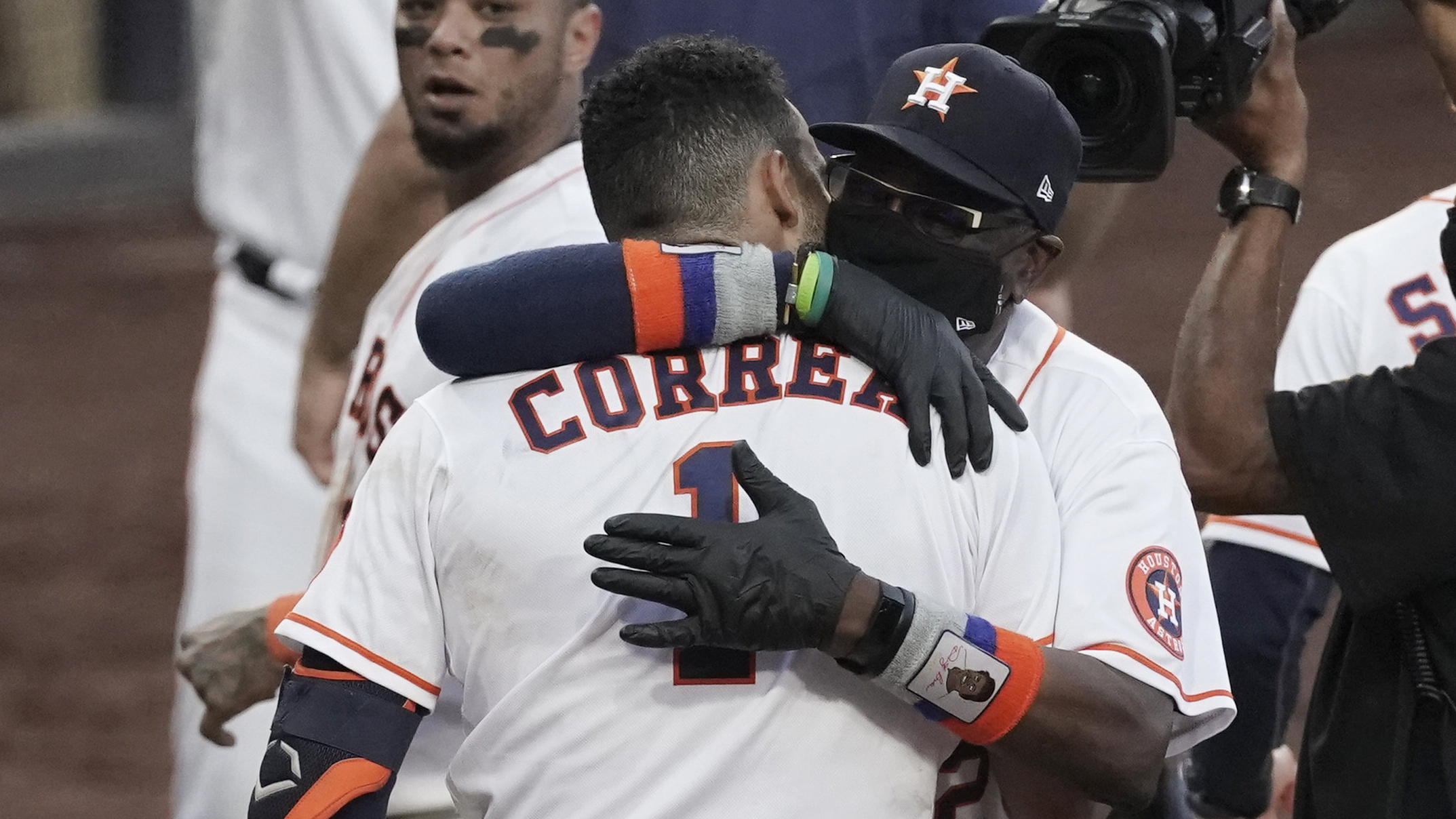 Houston Astros Carlos Correa is hugged by Houston Astros manager Dusty Baker Jr. after his walk off home run during the ninth inning in Game 5 of a baseball American League Championship Series, Tuesday, Dec. 15, 2020, in San Diego. The Astros defeated the Rays 4-3 and the Rays lead the series 3-2 games. (AP Photo/Ashley Landis)